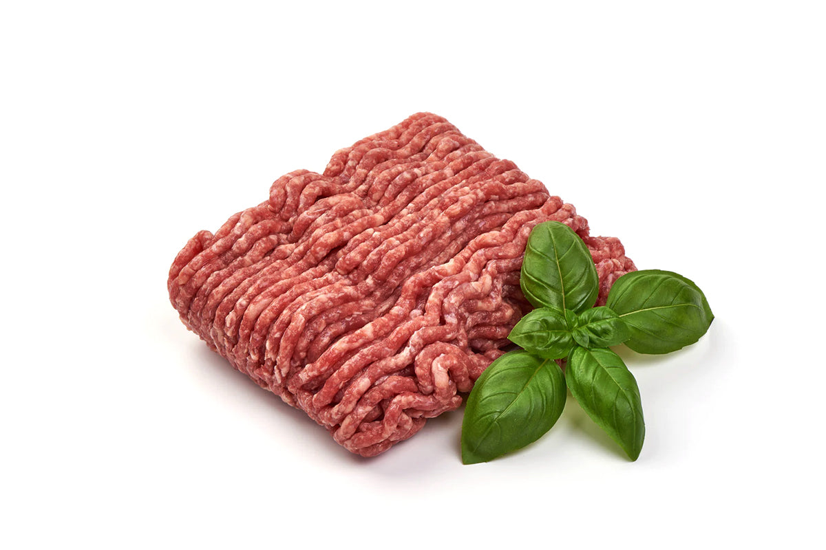 A block of fresh mince meat with visible fat strands, accompanied by a sprig of fresh basil, against a white background.