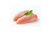Two raw chicken breasts on a white background with a sprig of parsley on top.
